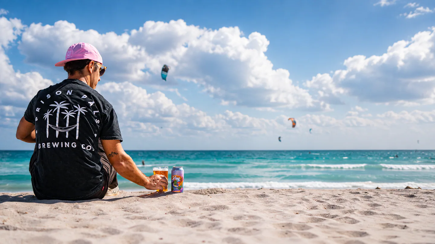 Person wearing a Prison Pals shirt with beer on Miami Beach.